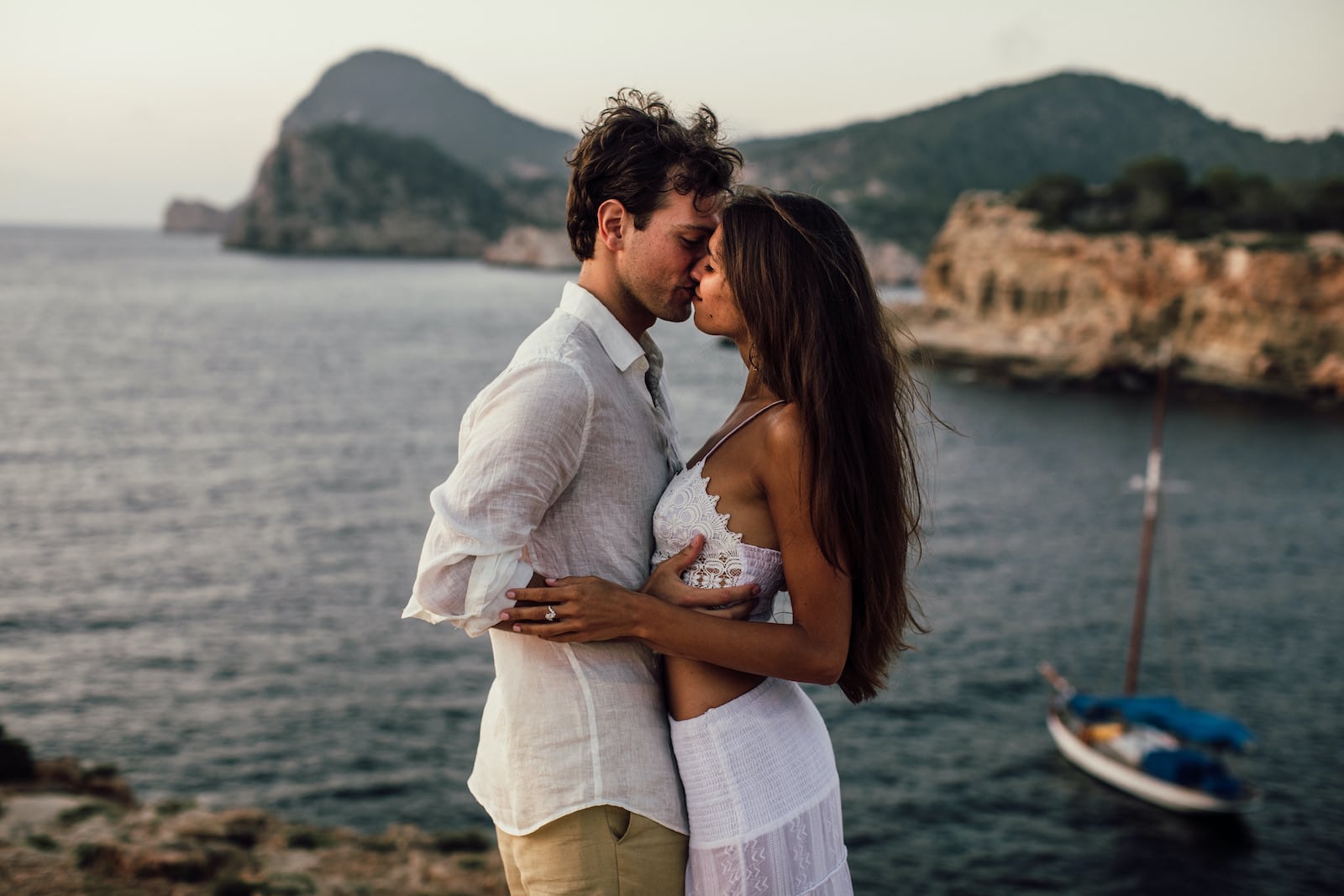 Ibiza, Spain intimate kiss during a photo session overlooking the sea by Lilly Red